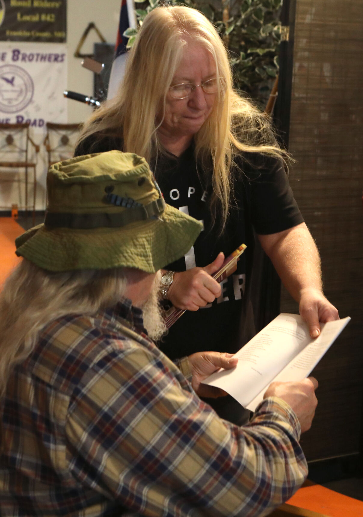 Donna Fowler hands out books